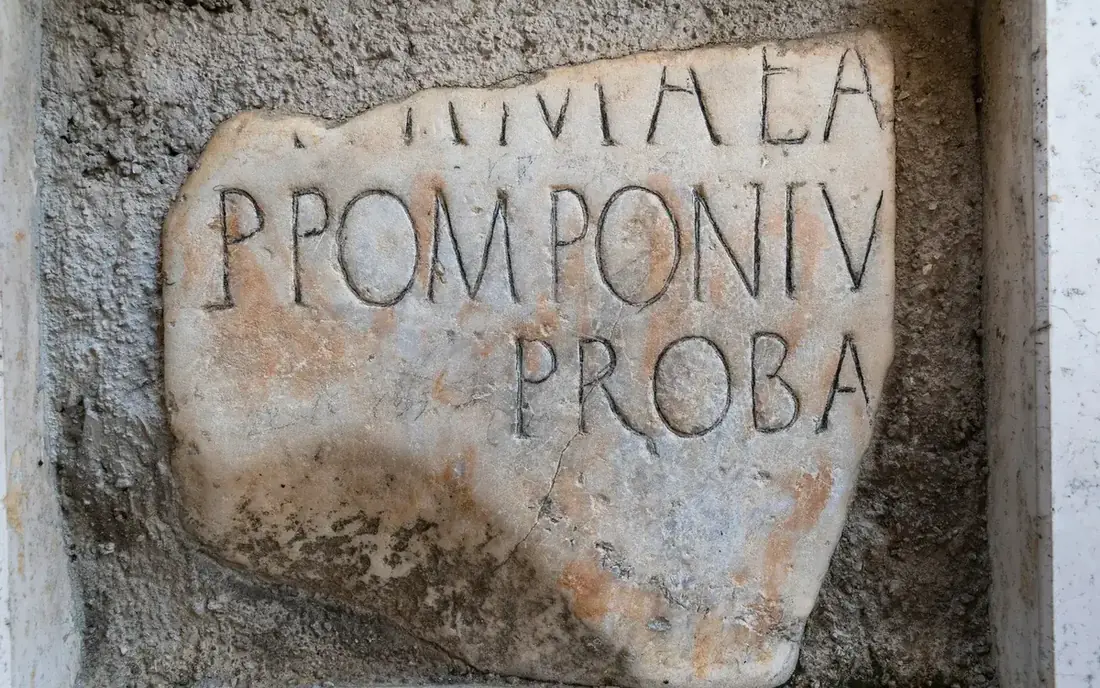 A fragment of ancient marble carved with Roman capital letters